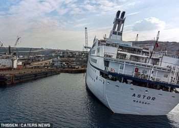 Inside a real-life ghost ship: Extraordinary pictures of massive vessel captured by explorers before it was sent to the scrap heap show luxury boat in an eerie light