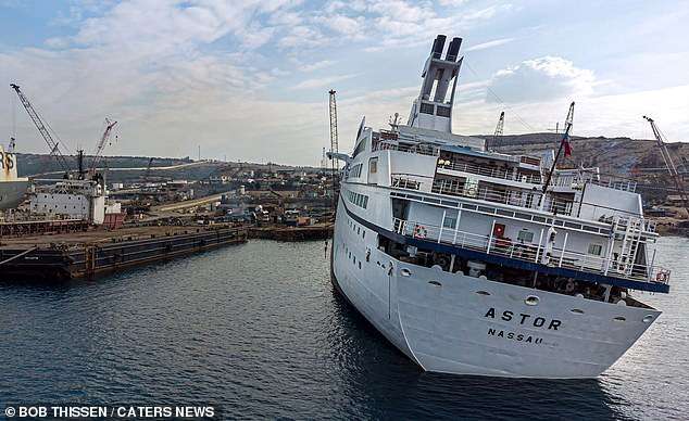 Inside a real-life ghost ship: Extraordinary pictures of massive vessel captured by explorers before it was sent to the scrap heap show luxury boat in an eerie light