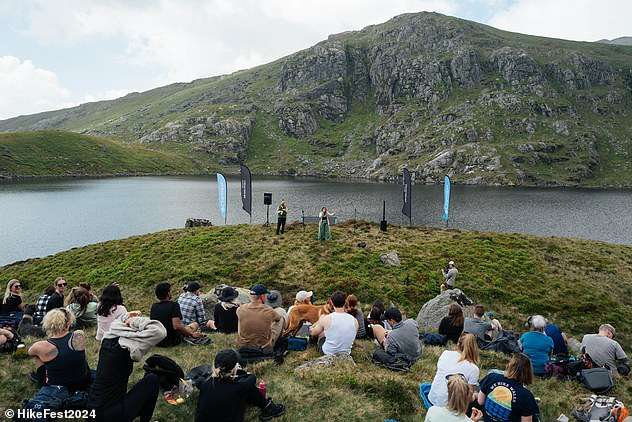‘The hills were alive with the sound of music’: Music fans hike up to seven hours to ‘UK’s most remote gig’ – at a reservoir deep in the Snowdonia mountains