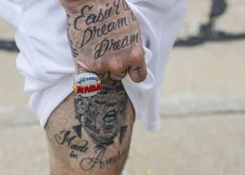 MAGA fans show off Trump tattoos and mugshot t-shirts as they line up hours before his Wisconsin rally… days after he called Milwaukee a ‘horrible city’