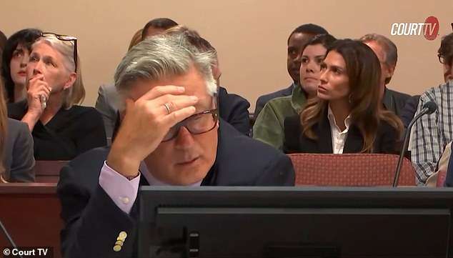 Alec Baldwin, 66, looks devastated as footage of Rust cinematographer Halyna Hutchins lifted onto a stretcher after fatal shooting is shown to the jury