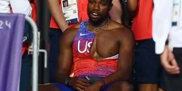 Noah Lyles has COVID but insists he has NO regrets about running 200m – despite needing to be wheeled off the track in Paris