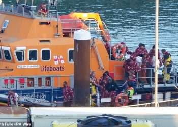 Nearly 1,000 migrants cross the English Channel in small boats on the busiest day in two years as four people die trying to make the journey