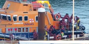 Nearly 1,000 migrants cross the English Channel in small boats on the busiest day in two years as four people die trying to make the journey