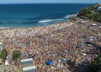 Jaw dropping vision shows thousands of Christmas revellers descend on Bronte beach in Sydney – and locals left to clean up the mess are furious