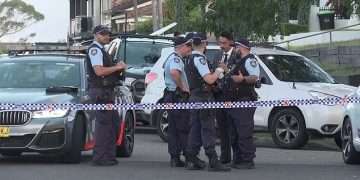 Man is shot dead in a suspected gangland hit in western Sydney – as cops hunt for the gunman and discover a burnt out car nearby