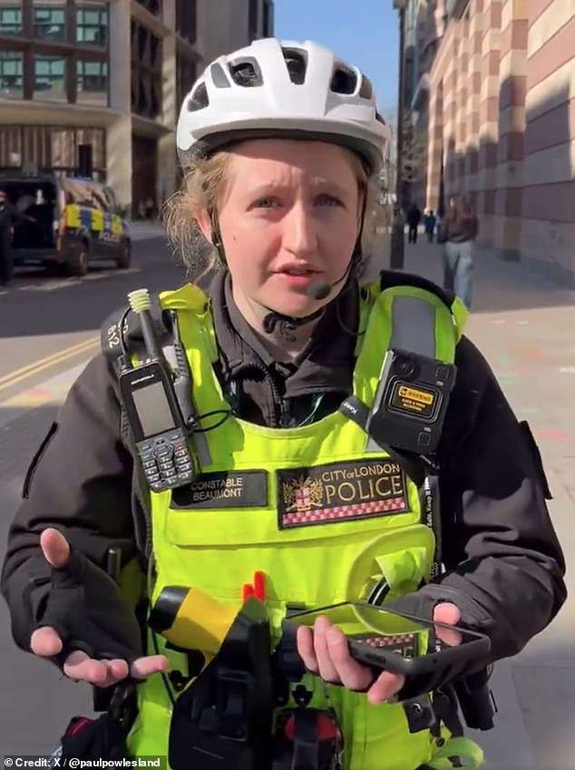 Moment cyclist ticketed for ‘riding no handed’ confronts City of London officer over his fine – but who do YOU think was in the wrong?