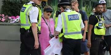 ‘Pink Lady’ anti-migrant protesters in stand-off with police at Canary Wharf amid fresh demonstration chaos after ‘migrant entered blind woman’s flat’