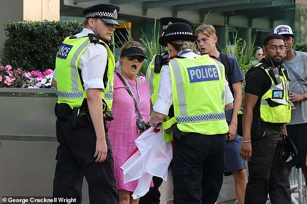 ‘Pink Lady’ anti-migrant protesters in stand-off with police at Canary Wharf amid fresh demonstration chaos after ‘migrant entered blind woman’s flat’