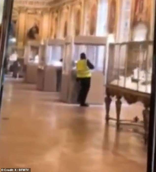 Moment ‘thief in a high-viz vest’ breaks into glass cabinet at the Louvre during seven-minute daylight raid: Police hunting for gang of criminals after priceless Napoleonic jewels stolen