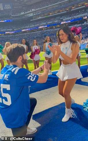 NFL cheerleader gets engaged mid-game after her boyfriend sneaks on the field wearing ‘Marry Me’ jersey