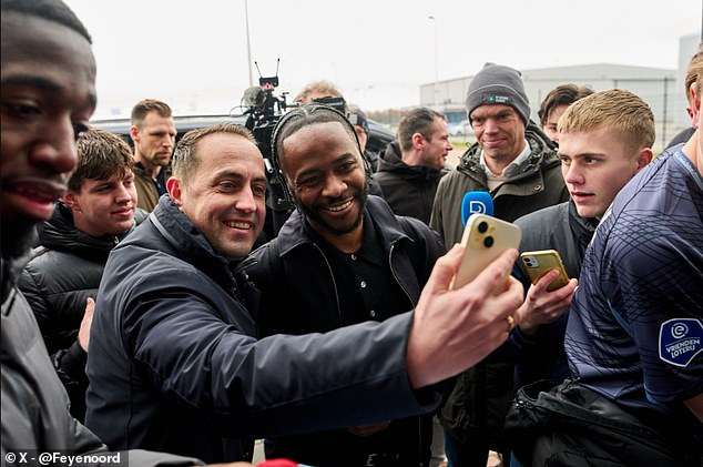 Raheem Sterling touches down in Holland: Former England star mobbed at airport after linking up with Premier League legend in surprise switch after Chelsea nightmare