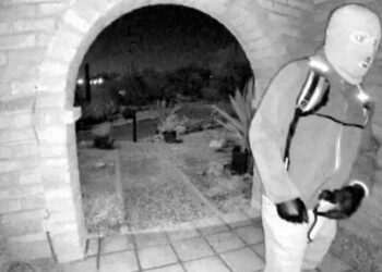 Terrifying masked figure in latex gloves with gun seen on Nancy Guthrie’s doorstep on morning of her kidnap