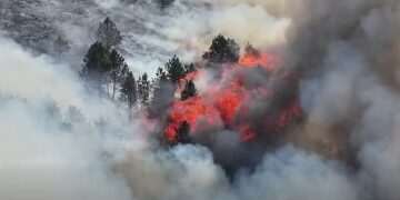 Wildfire burns in Peak District as Britain records hottest June day again and red weather warning is extended