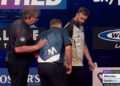 Darts star has to be helped off stage after suffering health scare during World Matchplay clash as he’s forced to withdraw from tournament
