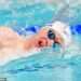 Sean McCann is cheered on by proud parents Kate and Gerry as he swims in Commonwealth 400m freestyle final two decades after older sister Madeleine vanished